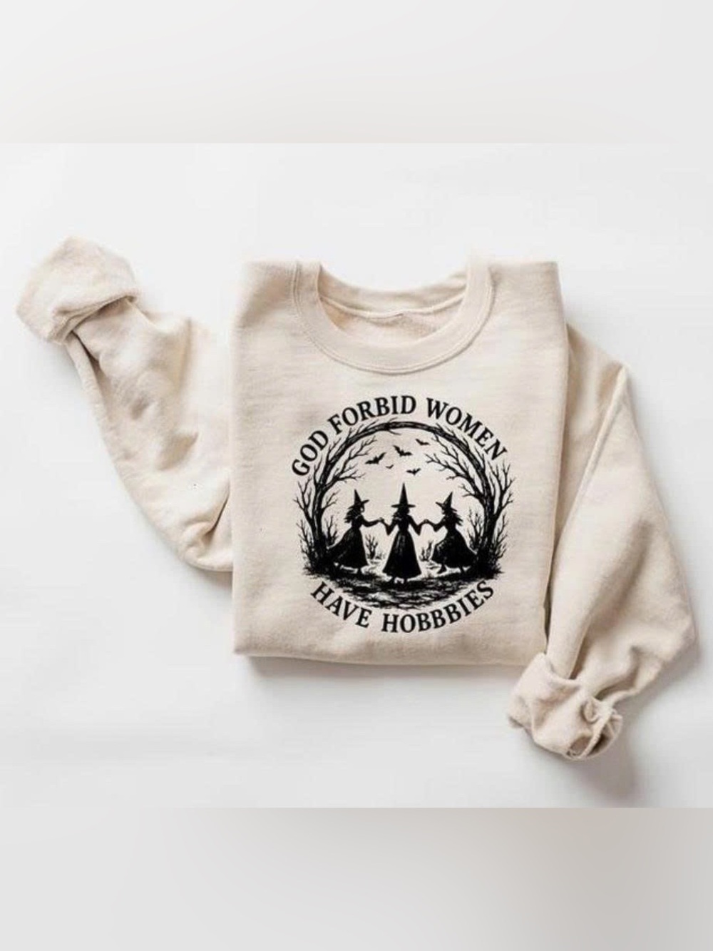 "God Forbid Women Have Hobbies." Cream Crewneck Sweatshirt with Black Witch G